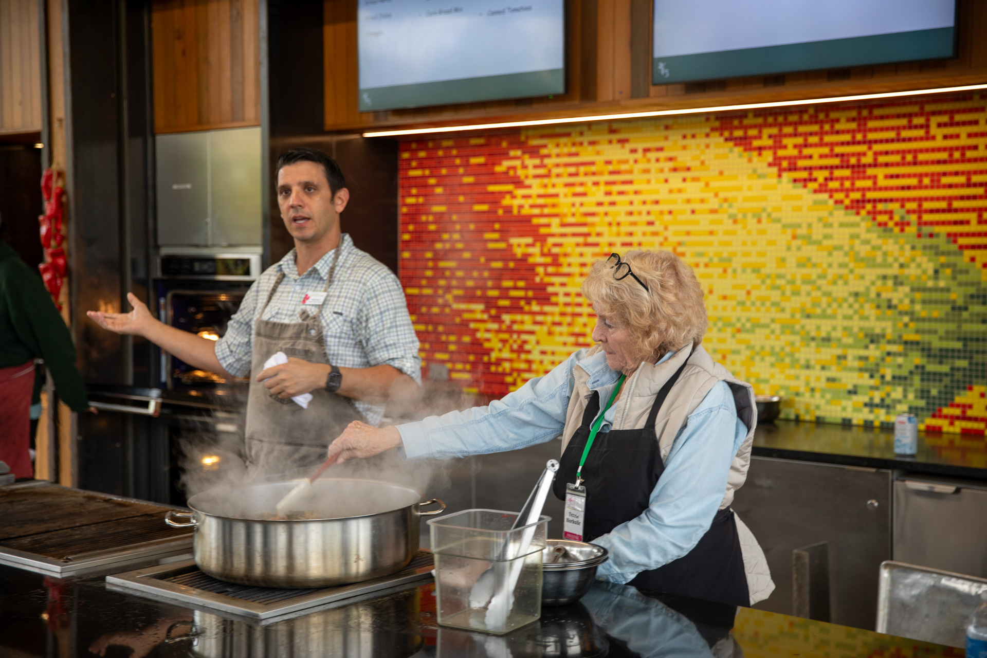 Chef Mark Weaver cooking in the Outdoor Teaching Kitchen with a guest